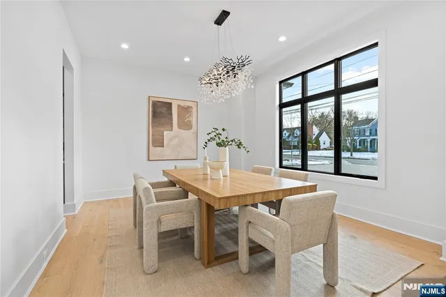 a dining room with furniture a chandelier and window