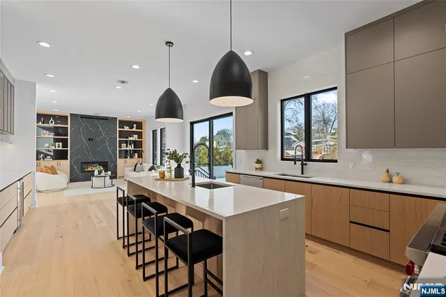 a kitchen with a sink a stove and chairs