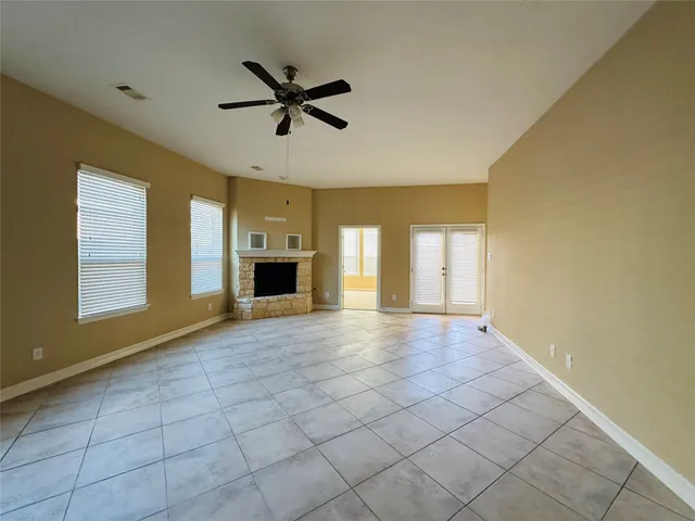 a view of a livingroom with a ceiling fan and window