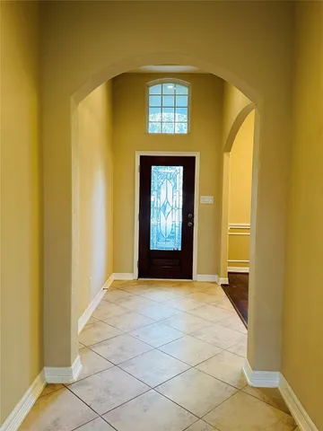 a view of an empty room with window and bathroom