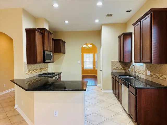 a kitchen with a sink and a refrigerator