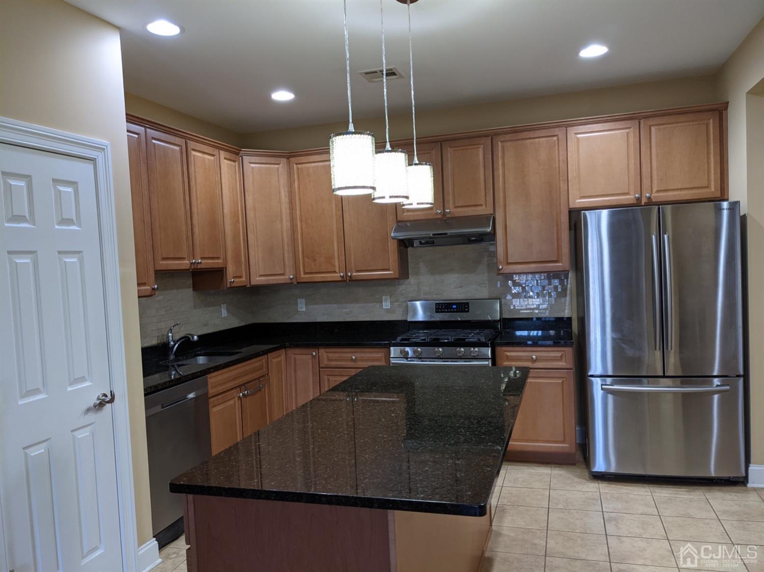 32 Cinder Road, Unit 23 Edison, NJ 08820 - Photo 1 of 6 a kitchen with stainless steel appliances granite countertop a refrigerator a sink dishwasher a stove and a refrigerator