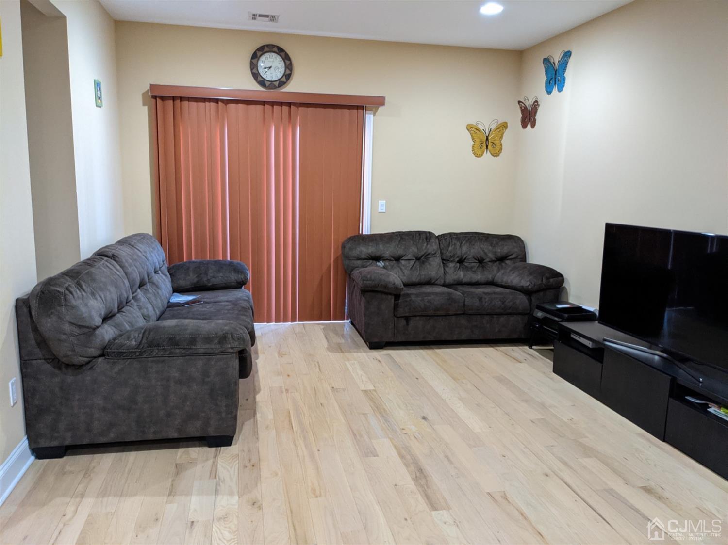 32 Cinder Road, Unit 23 Edison, NJ 08820 - Photo 3 of 6 a living room with furniture and a flat screen tv