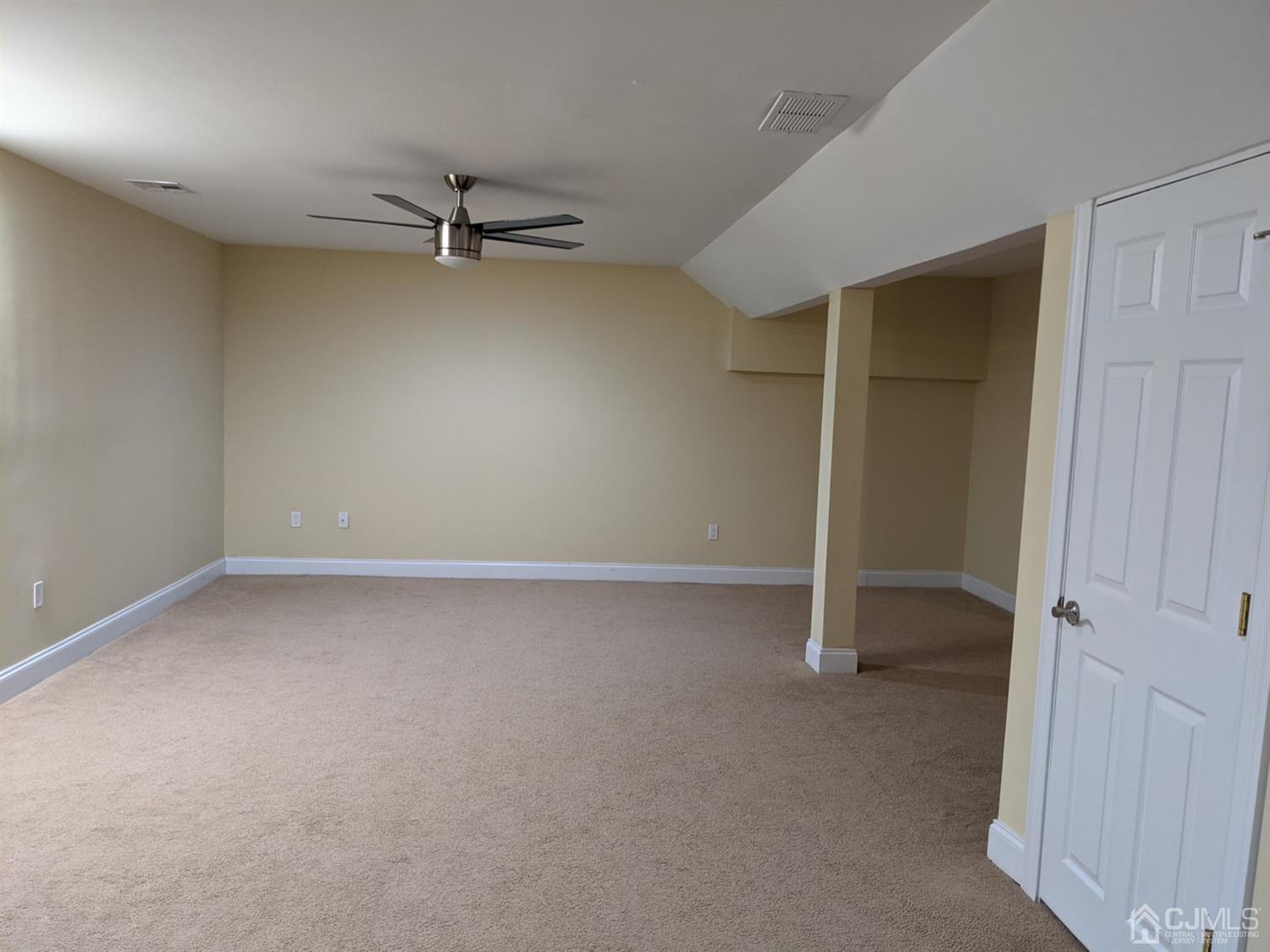 32 Cinder Road, Unit 23 Edison, NJ 08820 - Photo 5 of 6 an empty room with a ceiling fan