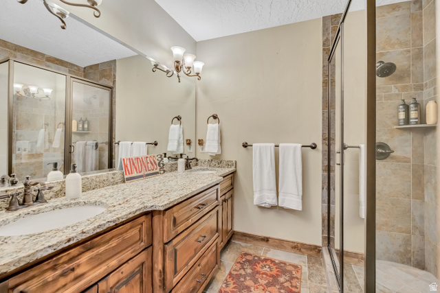 9049 Timphaven Road Sundance, UT 84604 - Photo 50 of 63 Bathroom with double vanity and a shower stall
