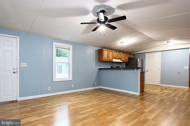 a view of empty room with wooden floor