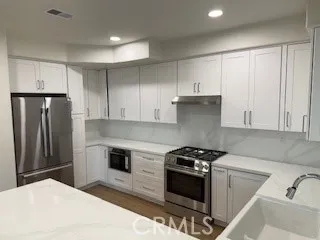 a kitchen with a sink stove and refrigerator
