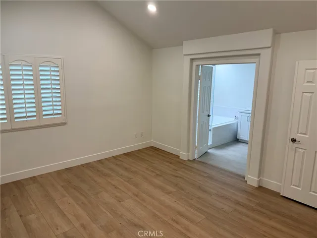a spacious bathroom with a tub sink and mirror