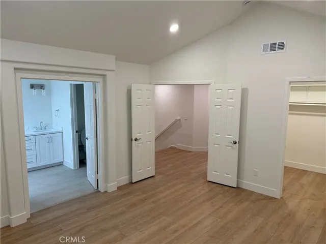 a bathroom with a granite countertop sink a toilet and a mirror