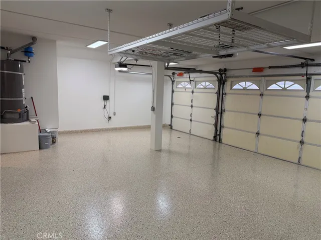 a view of a patio with table and chairs and wooden fence