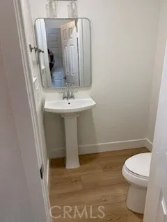 a white toilet sitting next to a bathroom sink