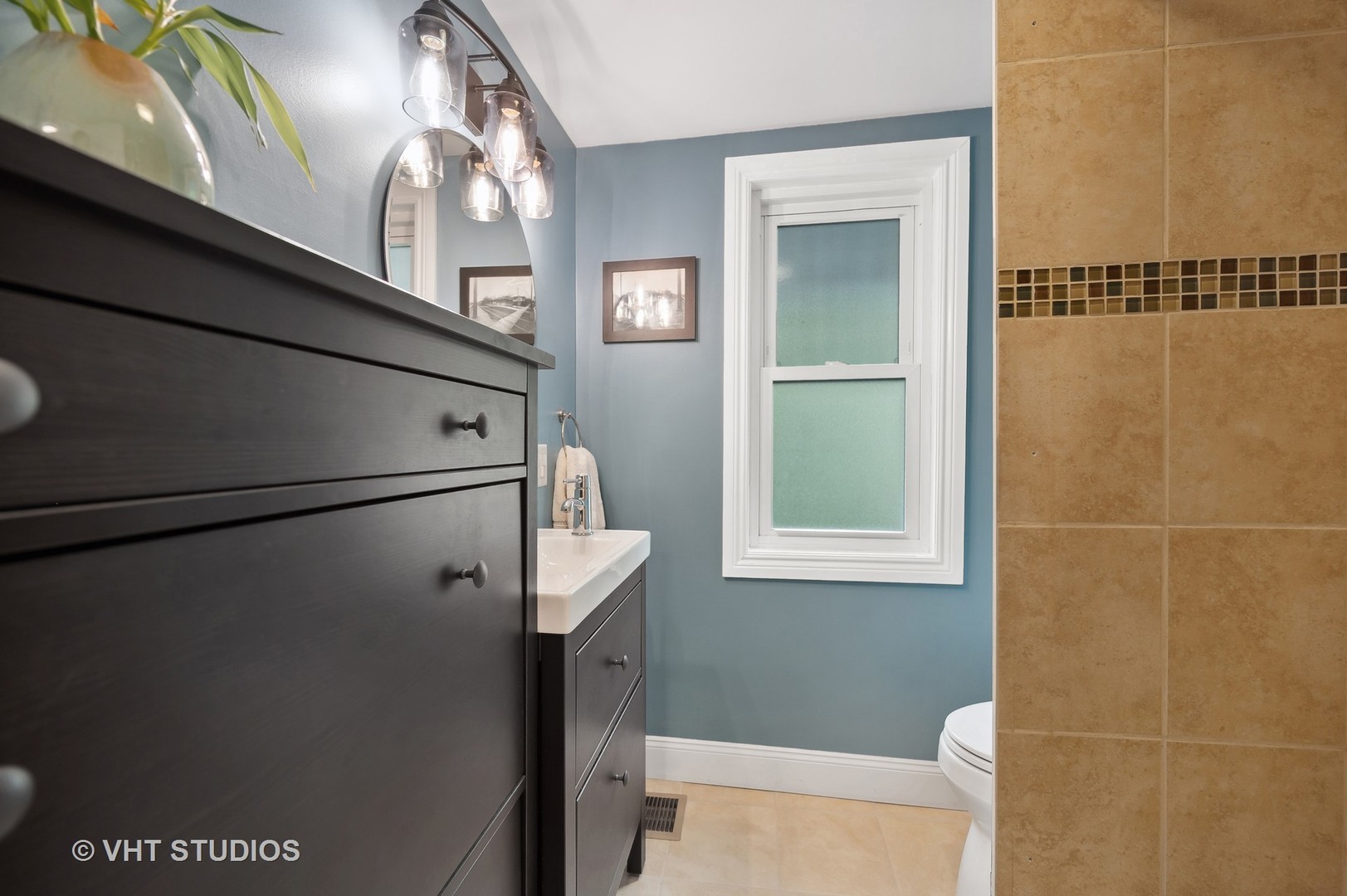 972 Tower Road Winnetka, IL 60093 - Photo 15 of 26 a bathroom with a window a toilet and a shower