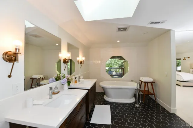 a bathroom with a sink toilet and a mirror