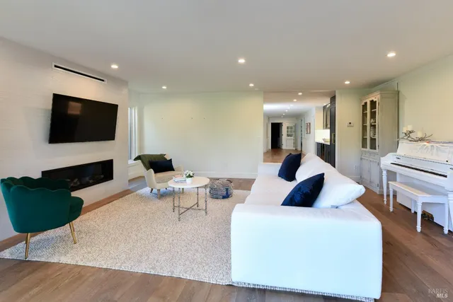 a living room with fireplace furniture and a flat screen tv