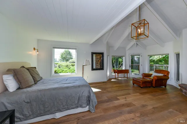 a spacious bedroom with a bed and a couch