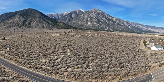 a view of a field with a mountain in the background