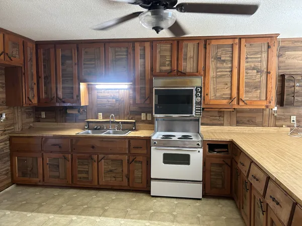 a kitchen with a stove sink and cabinets