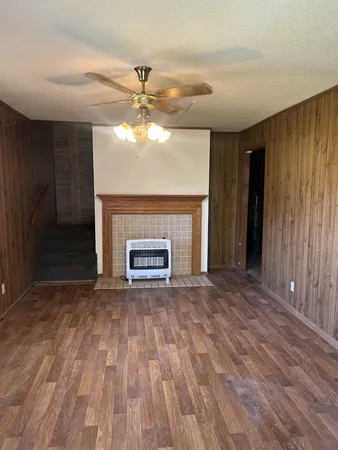 a view of empty room with fireplace and fan
