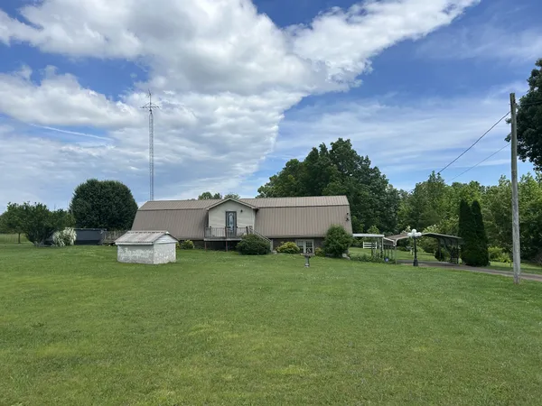 a view of a house with a yard and sitting area