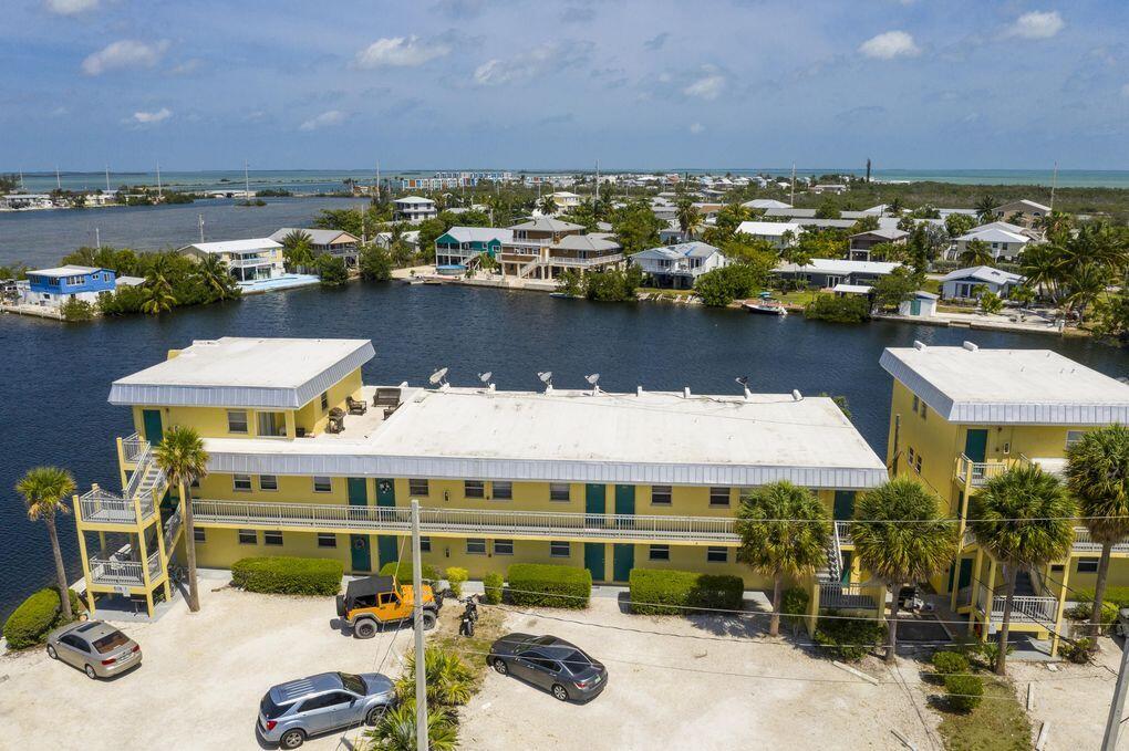 201 Coppitt Road, Unit 104B Key West, FL 33040 - Photo 11 of 13 a view of a lake with a building and outdoor space