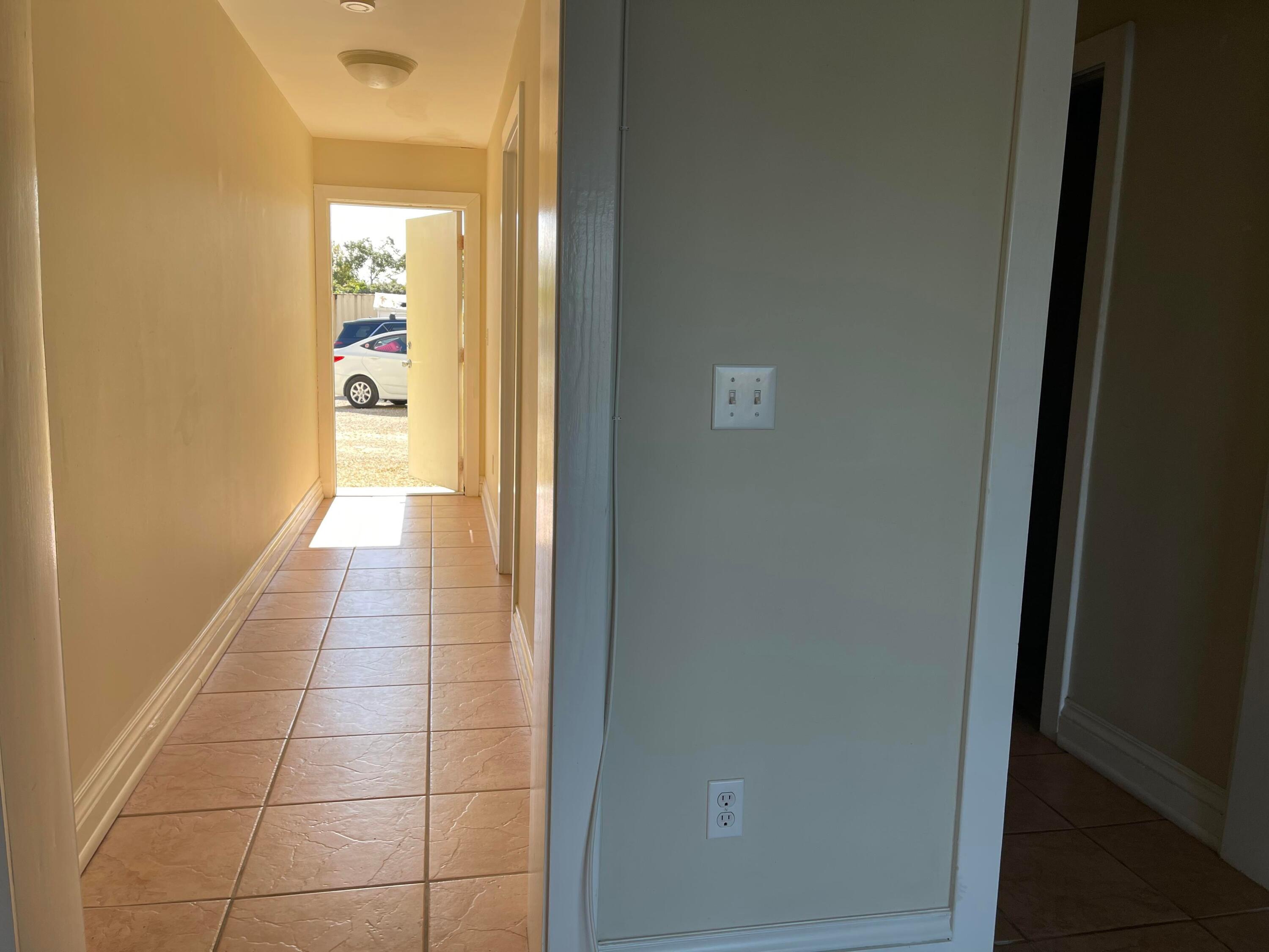 201 Coppitt Road, Unit 104B Key West, FL 33040 - Photo 4 of 13 a hallway with a wooden floor