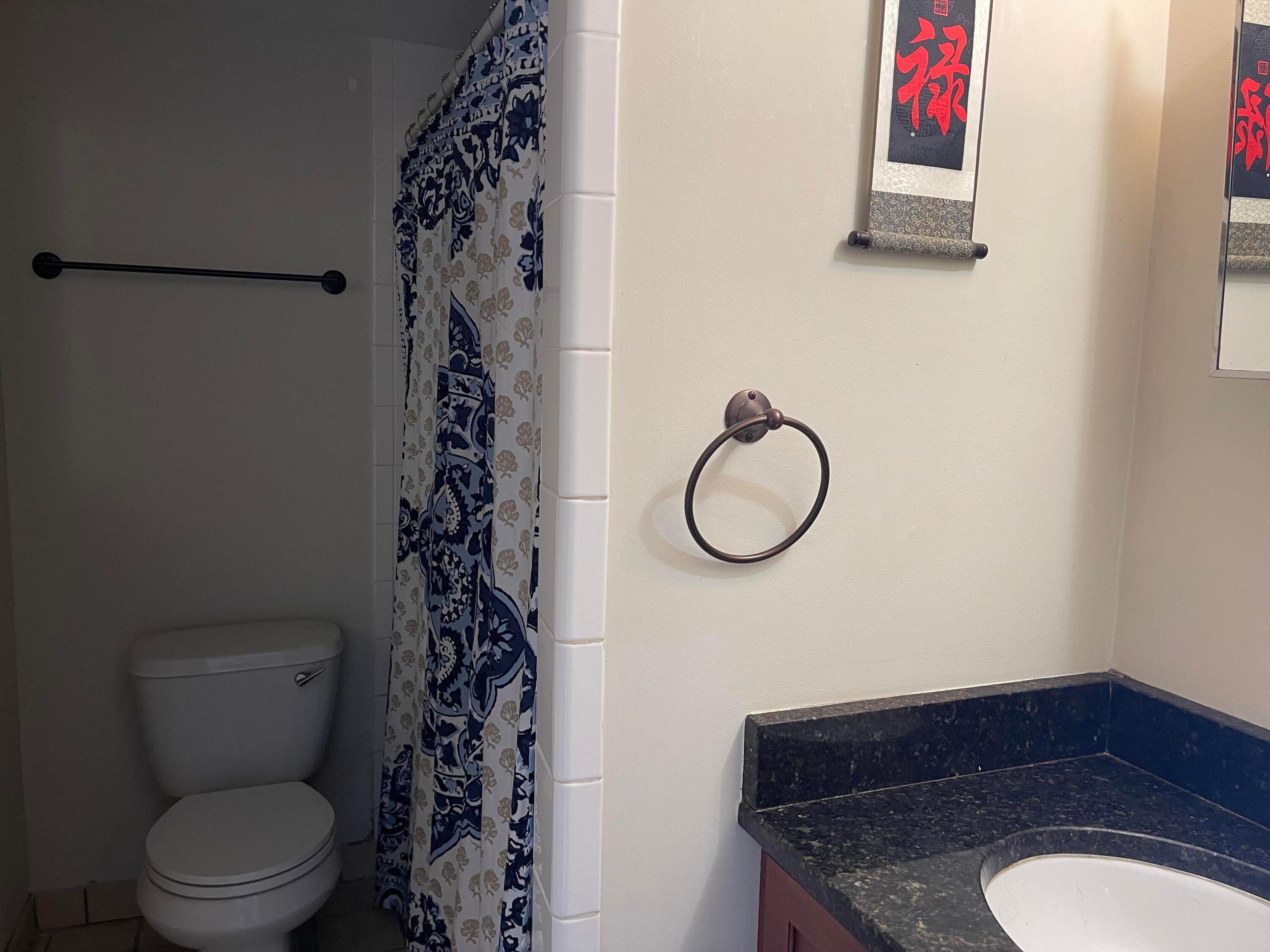 201 Coppitt Road, Unit 104B Key West, FL 33040 - Photo 6 of 13 a bathroom with a toilet a sink and a mirror