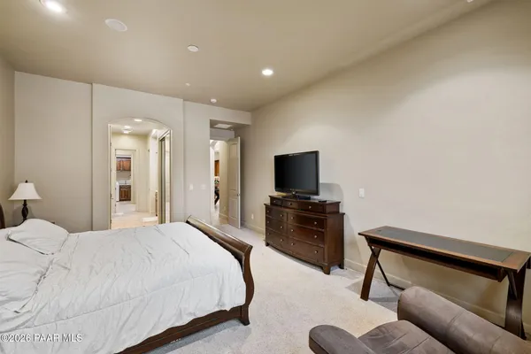 a bedroom with bed and a flat screen tv