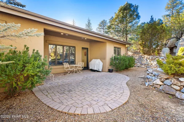 a view of a house with backyard and sitting area