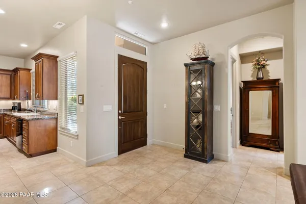 a view of a hallway with kitchen and refrigerator