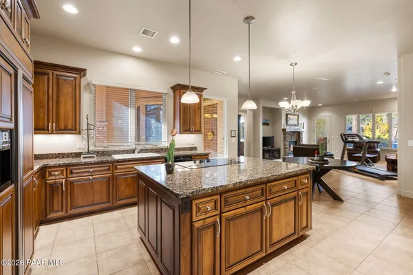 a large kitchen with kitchen island granite countertop a large counter top and sink