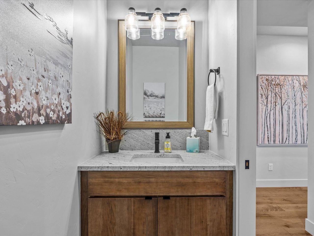 365 West Ridges Boulevard, Unit A Grand Junction, CO 81507 - Photo 23 of 42 a bathroom with a granite countertop sink and a mirror