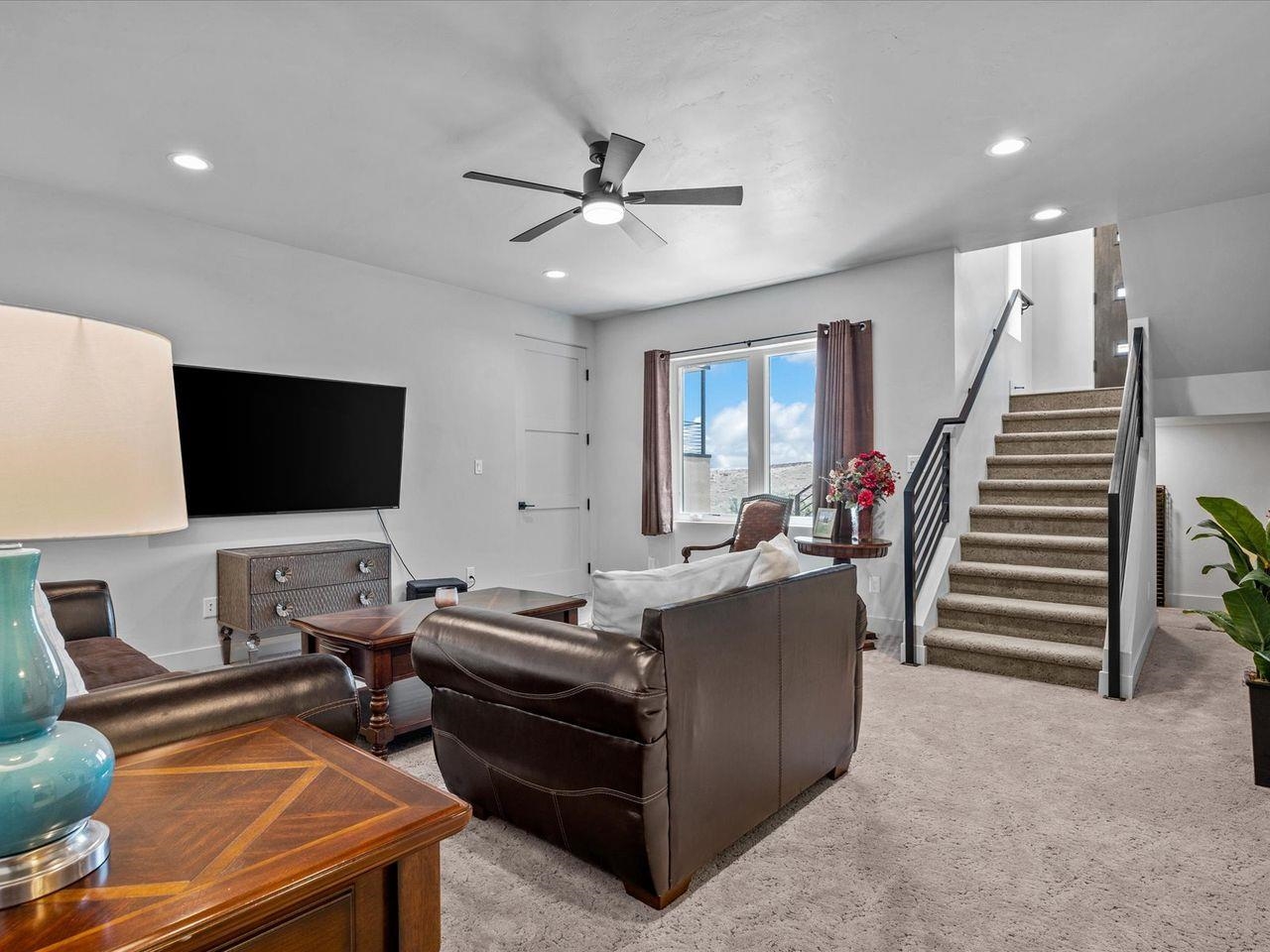 365 West Ridges Boulevard, Unit A Grand Junction, CO 81507 - Photo 31 of 42 a living room with furniture and a flat screen tv