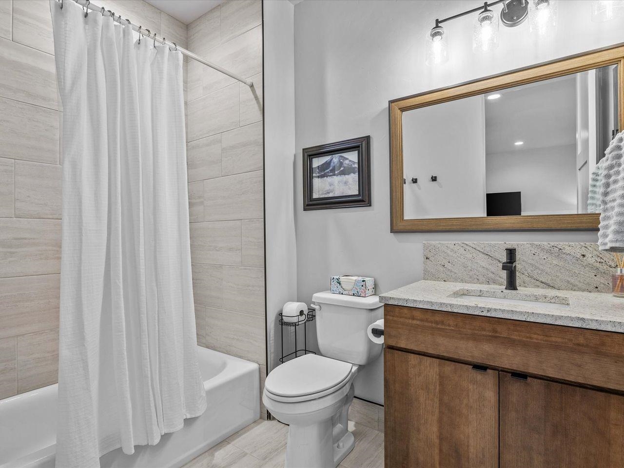 365 West Ridges Boulevard, Unit A Grand Junction, CO 81507 - Photo 33 of 42 a bathroom with a granite countertop sink toilet and shower