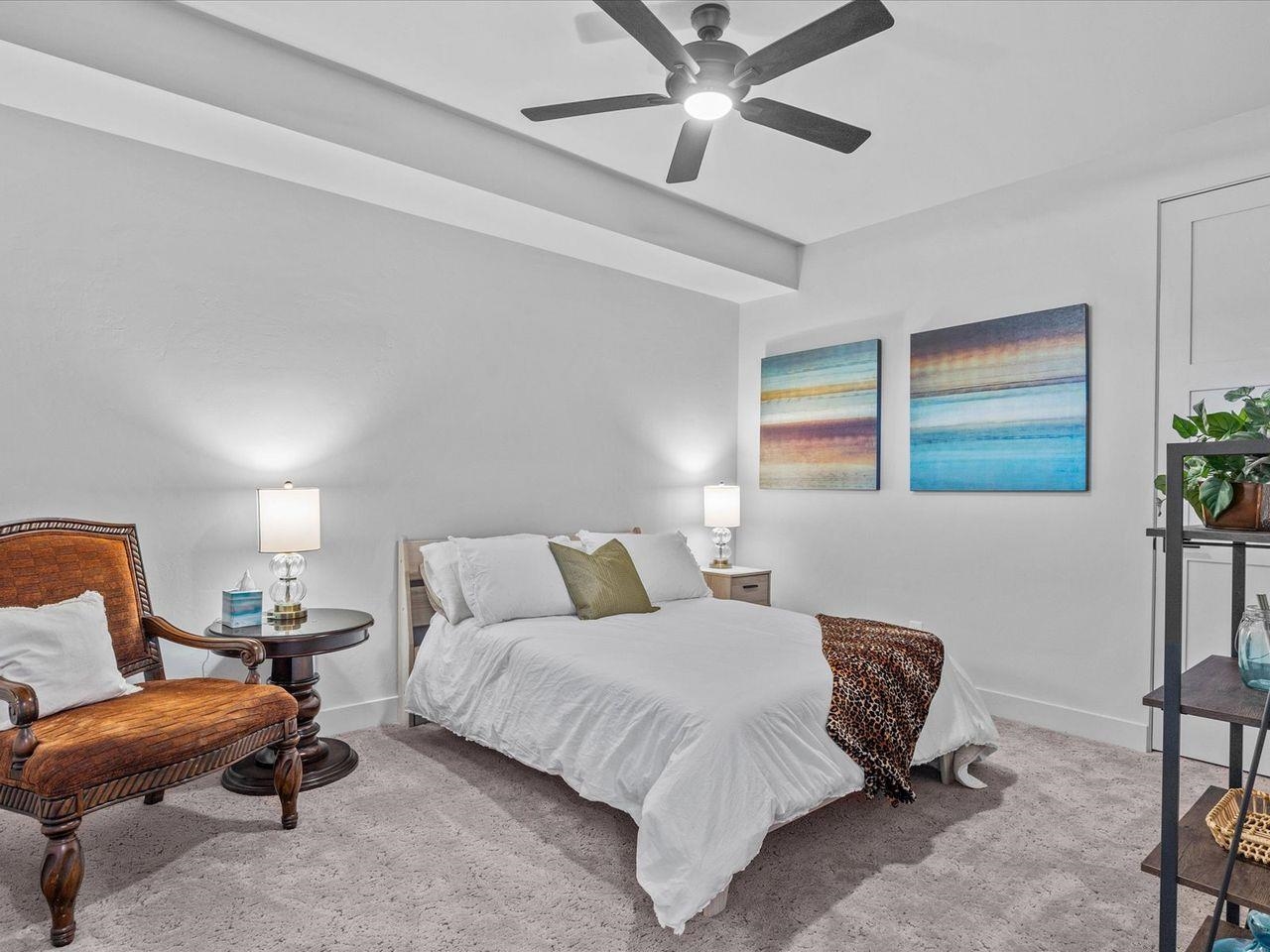 365 West Ridges Boulevard, Unit A Grand Junction, CO 81507 - Photo 34 of 42 a bedroom with a bed and a chandelier