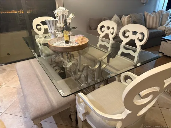 a dining room with furniture and wooden floor