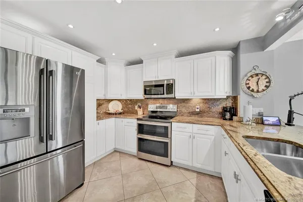 a kitchen with a sink appliances and cabinets