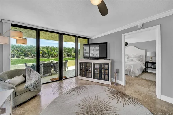 a bedroom with furniture and a large window