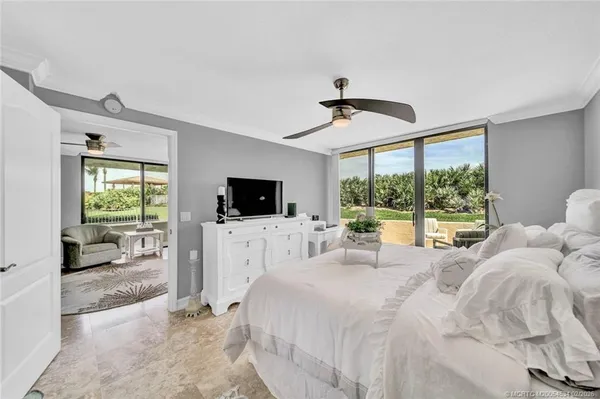 a large bedroom with a large bed and a flat screen tv