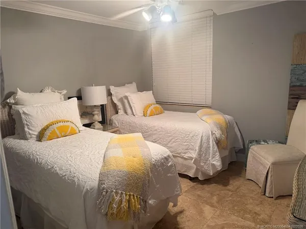 a bedroom with two beds and painted room