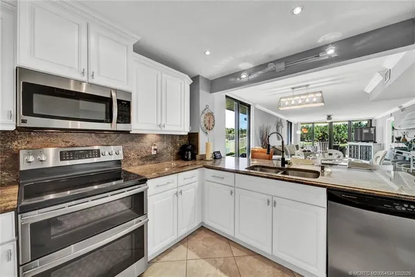 a kitchen with a sink stove and microwave