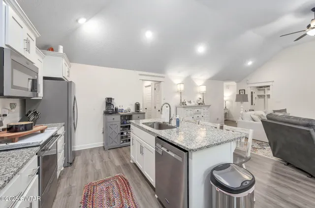 a kitchen with a stove a sink and a refrigerator