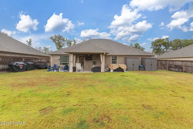 a view of a house with swimming pool having outdoor seating