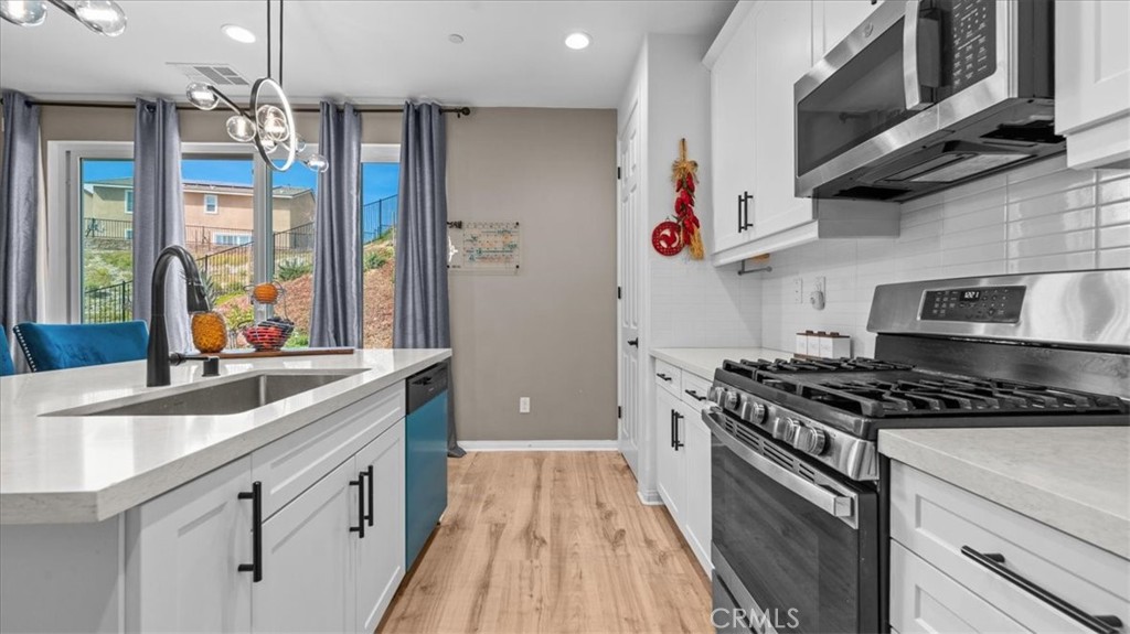 35580 Roxy Road Beaumont, CA 92223 - Photo 12 of 39 a kitchen with stainless steel appliances granite countertop a sink stove and refrigerator