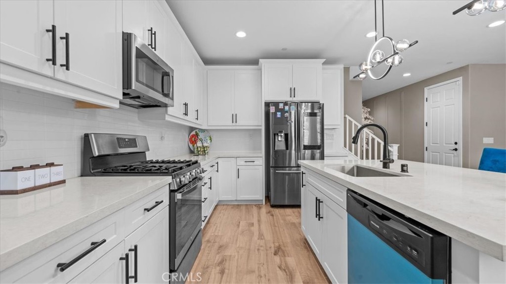 35580 Roxy Road Beaumont, CA 92223 - Photo 13 of 39 a kitchen with stainless steel appliances a sink stove and refrigerator