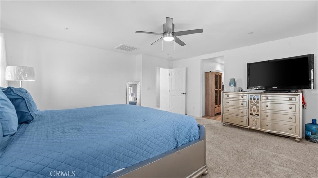 35580 Roxy Road Beaumont, CA 92223 - Photo 15 of 39 a bedroom with a bed and flat screen tv