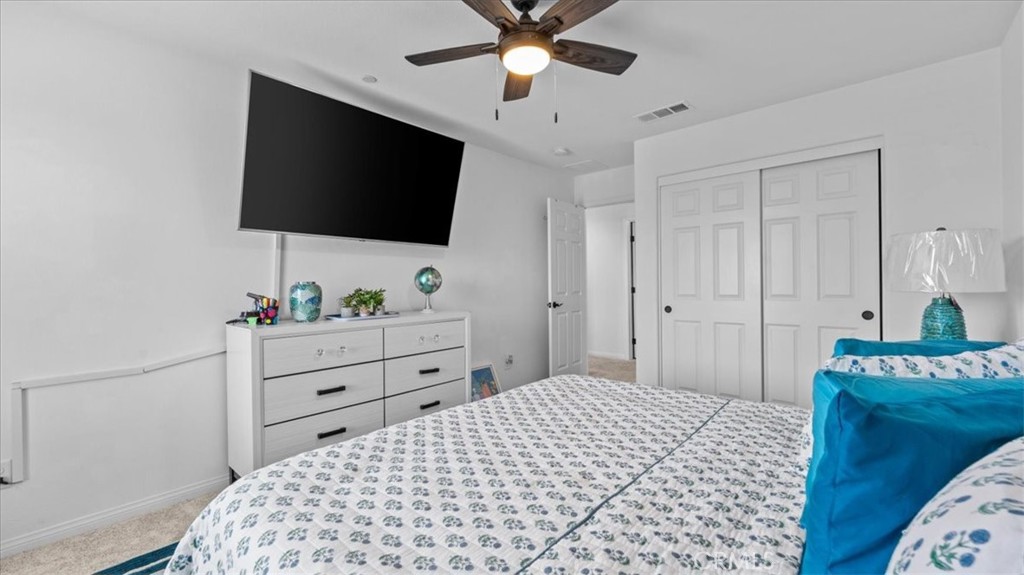 35580 Roxy Road Beaumont, CA 92223 - Photo 20 of 39 a bedroom with a bed and a flat screen tv