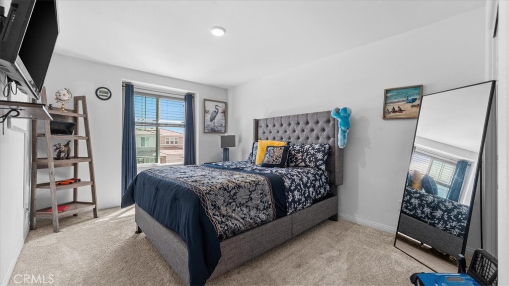 35580 Roxy Road Beaumont, CA 92223 - Photo 25 of 39 a bedroom with a bed and a flat tv screen