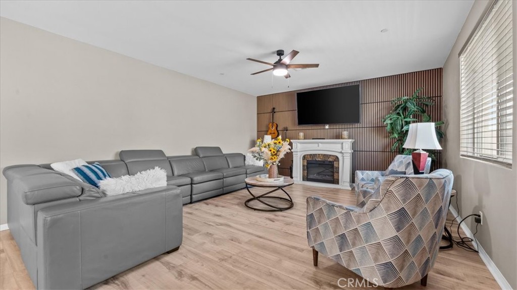 35580 Roxy Road Beaumont, CA 92223 - Photo 4 of 39 a living room with furniture a flat screen tv and a fireplace