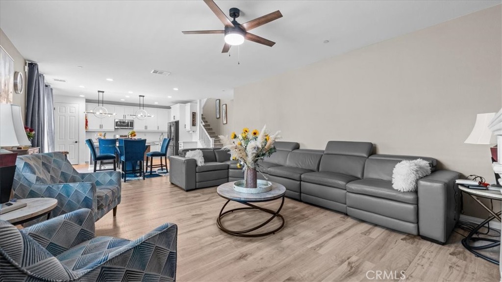 35580 Roxy Road Beaumont, CA 92223 - Photo 5 of 39 a living room with furniture or kitchen view and a chandelier