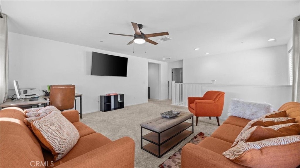 35580 Roxy Road Beaumont, CA 92223 - Photo 10 of 39 a living room with furniture and a flat screen tv